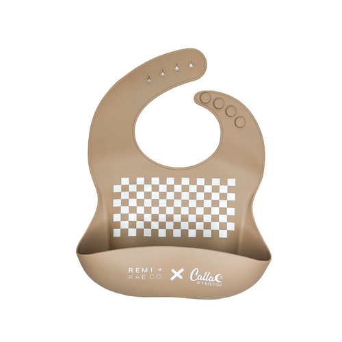 RRCO x C&F Checked Out Catch All Bib in silicone, angled view showcasing its stylish checkered design and functionality.