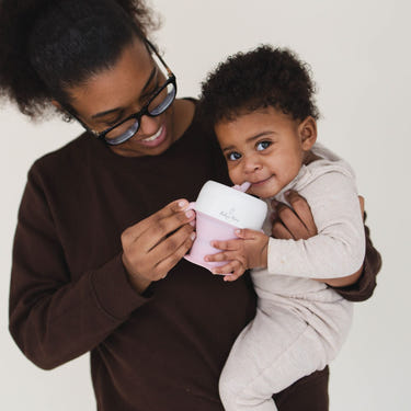 2 In 1 Snack Cups for babies, featuring a spill-proof design and easy-grip handles, perfect for on-the-go snacking.