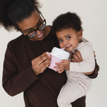 2 In 1 Snack Cups for babies, featuring a spill-proof design and easy-grip handles, perfect for on-the-go snacking.