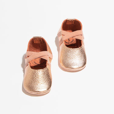 Rose gold ballet slipper baby shoe, perfect for little dancers and stylish outfits.