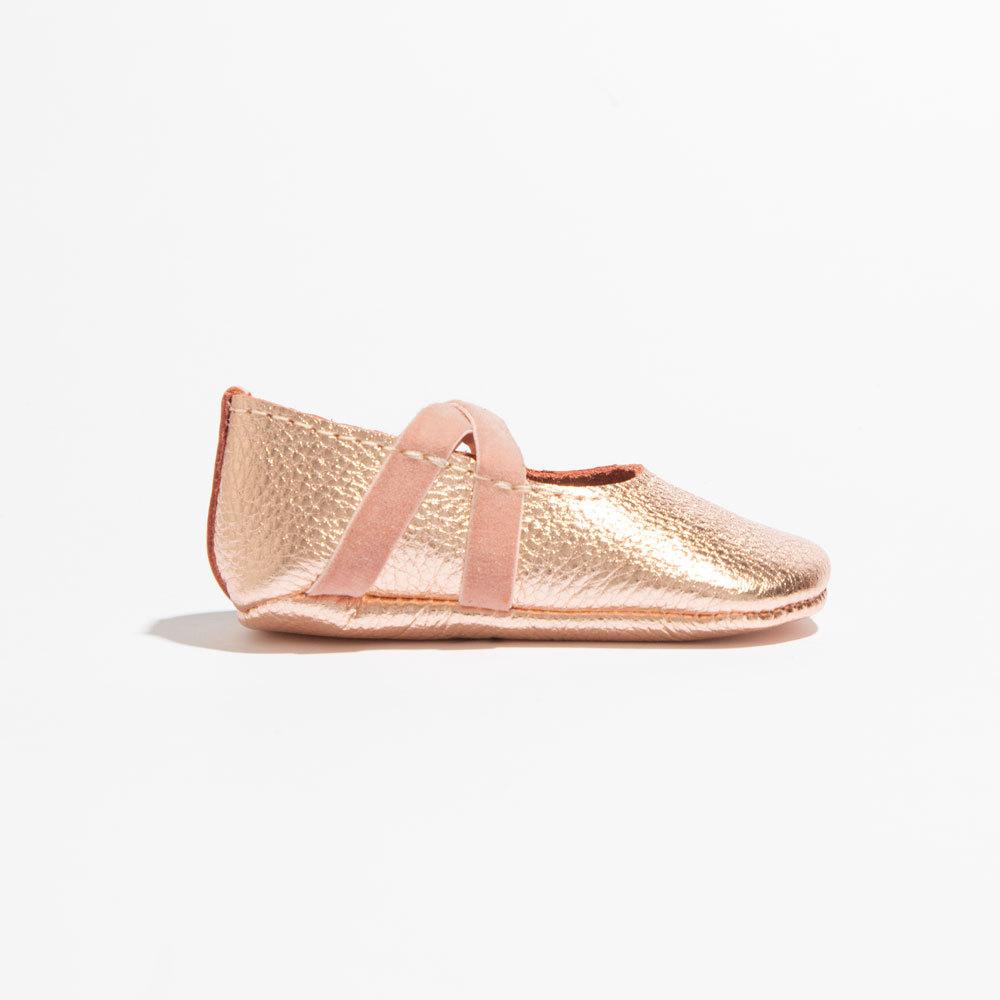 Rose gold ballet slipper baby shoe, perfect for little dancers and stylish outfits.