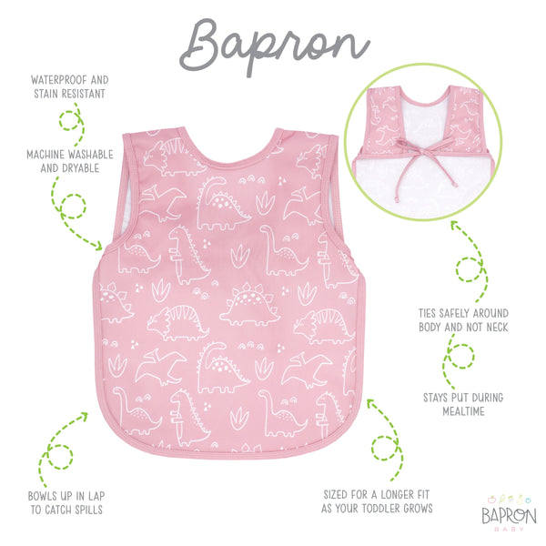 Blush Dino Friends Bapron for babies, featuring a playful dinosaur design, angled view showcasing its unique style.