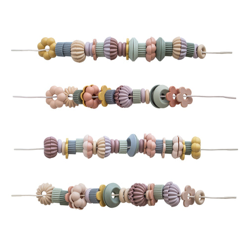 Colorful bead lacing toy set for babies, promoting fine motor skills and creativity in playtime.