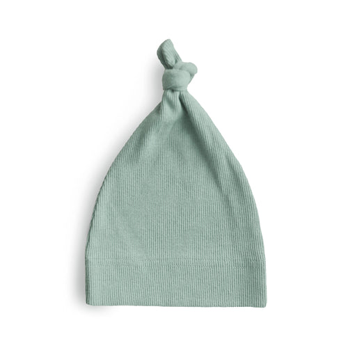 Ribbed baby beanie in soft fabric, angle view showcasing its cozy design and adorable style for infants.