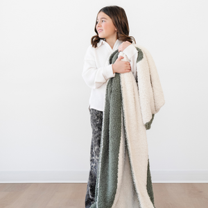 Double-layer Bamboni® toddler blankets in soft colors, perfect for swaddling and keeping your baby cozy.