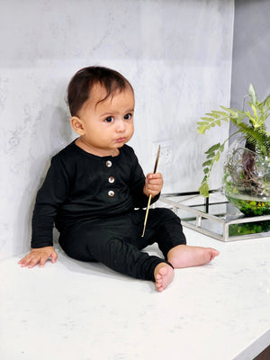 Newborn baby boy black outfit set with top, bottom, and hat, displayed at angle 5. Perfect for stylish comfort.