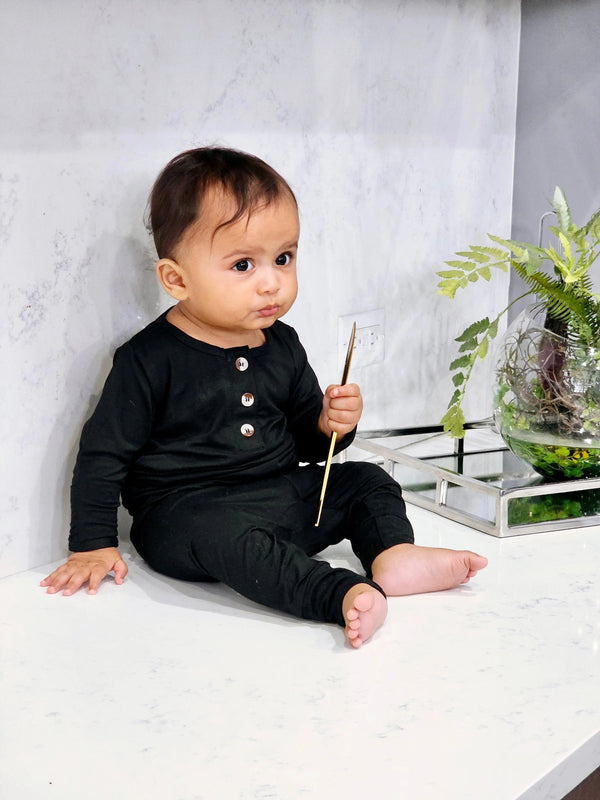 Newborn baby boy black outfit set with top, bottom, and hat, displayed at angle 5. Perfect for stylish comfort.