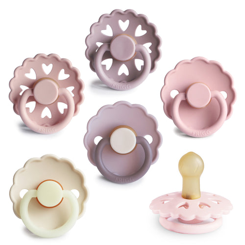 FRIGG Natural Rubber 6-Pack Pacifiers in various colors, angled view showcasing their soft, safe design for babies.