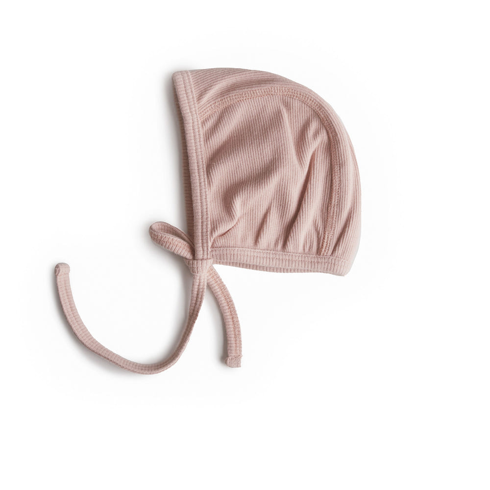 Ribbed baby bonnet in soft fabric, perfect for keeping little heads warm and stylish.