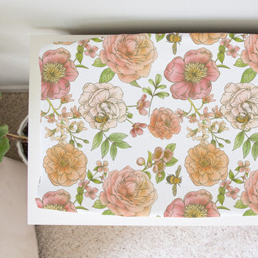 Botanical floral changing pad cover for babies, perfect for nursery decor and comfort during diaper changes.