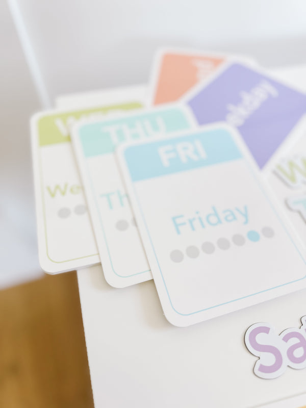 Colorful calendar flashcards and magnets for early learning, showcasing days, months, and seasons for sensory play.