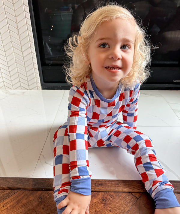 RWB Check Set for babies - cozy bedding and sleep essentials in a stylish red, white, and blue check pattern.