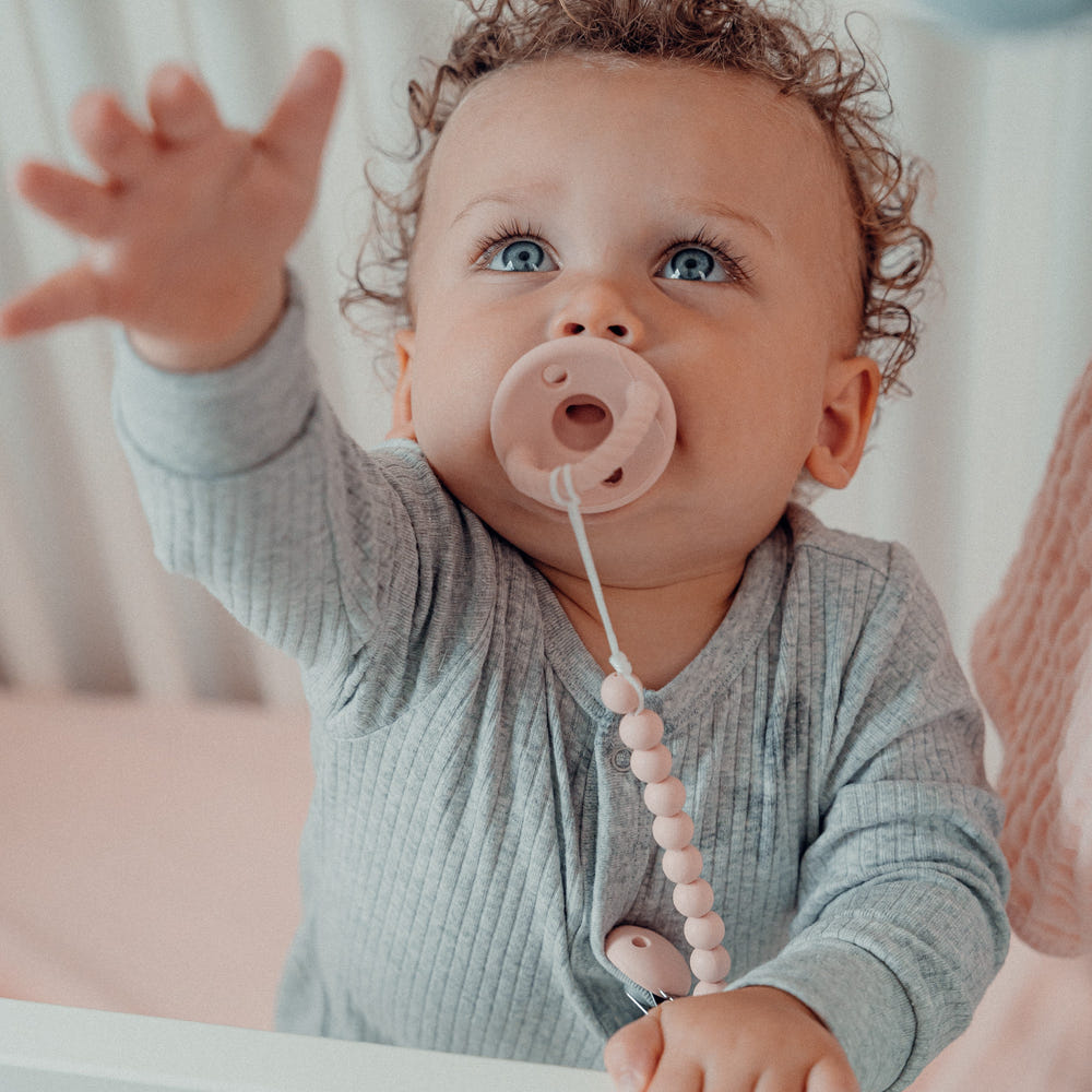 Pink blush pacifier clips, 2 pack, perfect for keeping pacifiers clean and accessible for your baby.