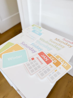 Colorful calendar flashcards and magnets for early learning, featuring days, months, and seasons for sensory play.