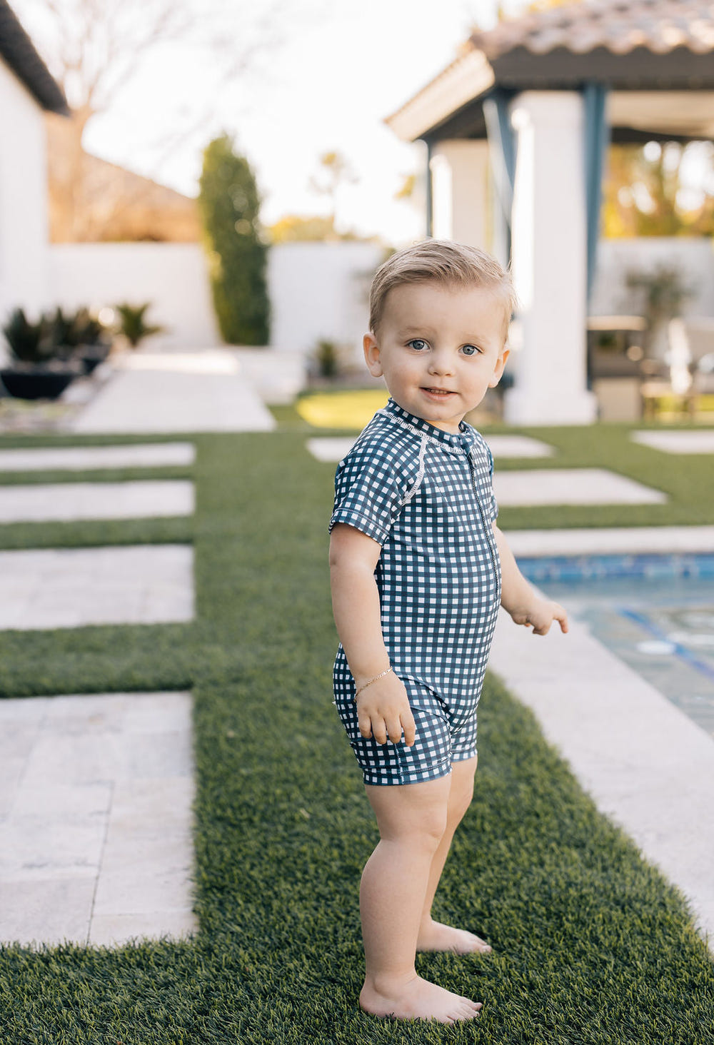 Navy gingham zipper swimsuit for babies, perfect for summer fun and stylish beach outings.