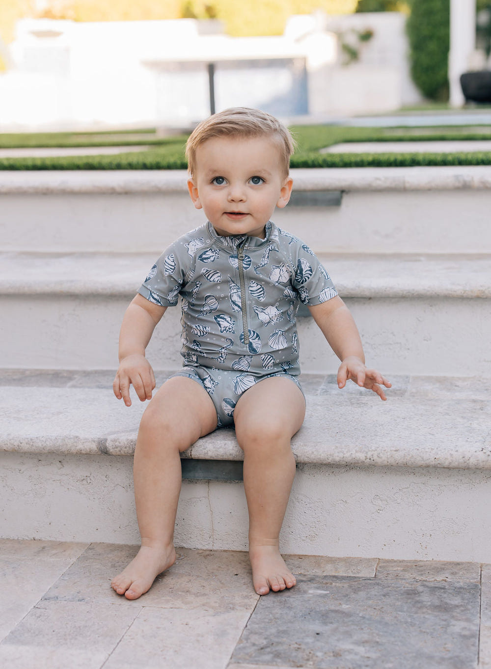 "Sea Shell Zipper Swimsuit for babies, perfect for beach days and diaper bag essentials."