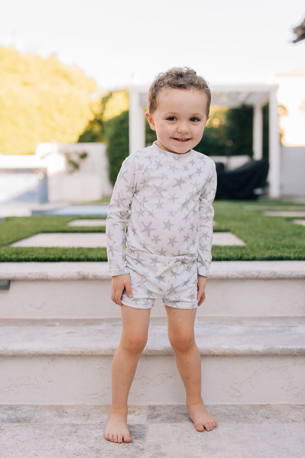Star Fish Long Sleeve Swim Set for babies, featuring a vibrant design in a two-piece bundle for sunny beach days.
