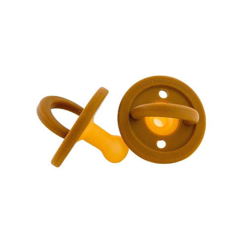 Modern caramel pacifier for babies, featuring a sleek design and safe materials. Perfect for soothing infants.