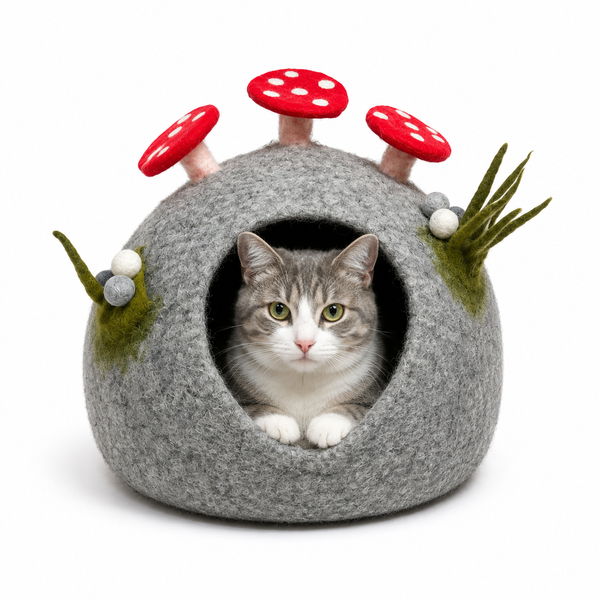 Felt mushroom cat cave in gray wool with red spotted mushroom caps, a cat peeking out from the opening
