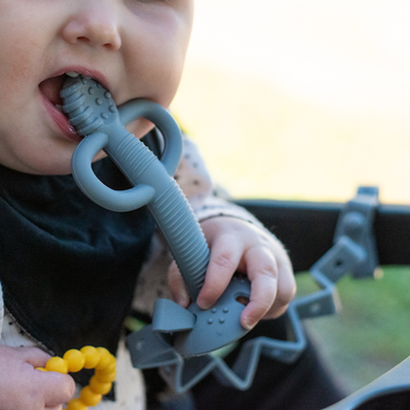 2-in-1 Teether & Training Spoon for babies, perfect for soothing gums and encouraging self-feeding.