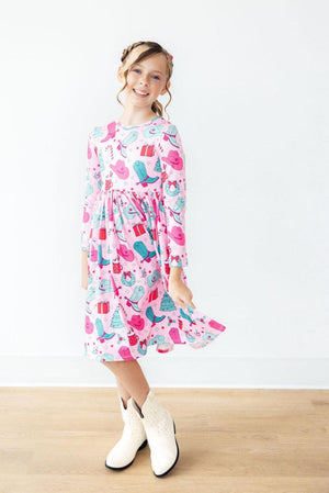 "Christmas Cowgirl long sleeve twirl dress with pocket, angle view showcasing festive design for baby girls."