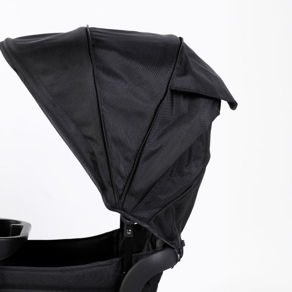 Oversized UV 50+ retractable canopy for baby strollers in Field Trip Black, shown from angle 2.