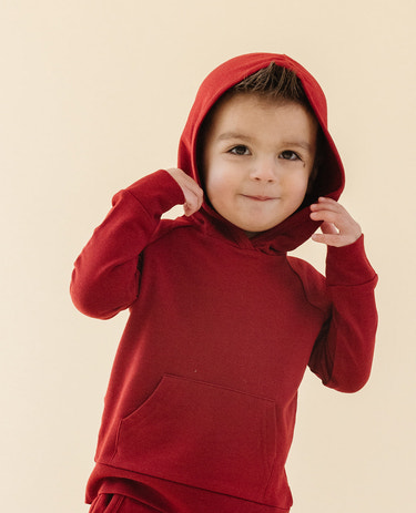 Cozy crimson hoodie for babies, perfect for warmth and style in any season.