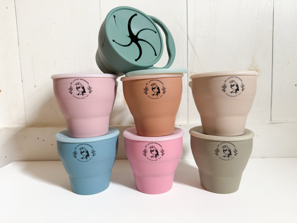 Silicone collapsible snack cups for babies, perfect for on-the-go snacks and easy storage.