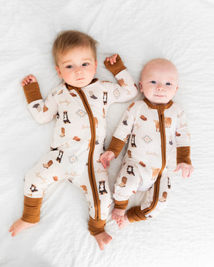 "Bedtime Buckaroo Zipper Lounger for babies in cozy loungewear, perfect for sleep and play."