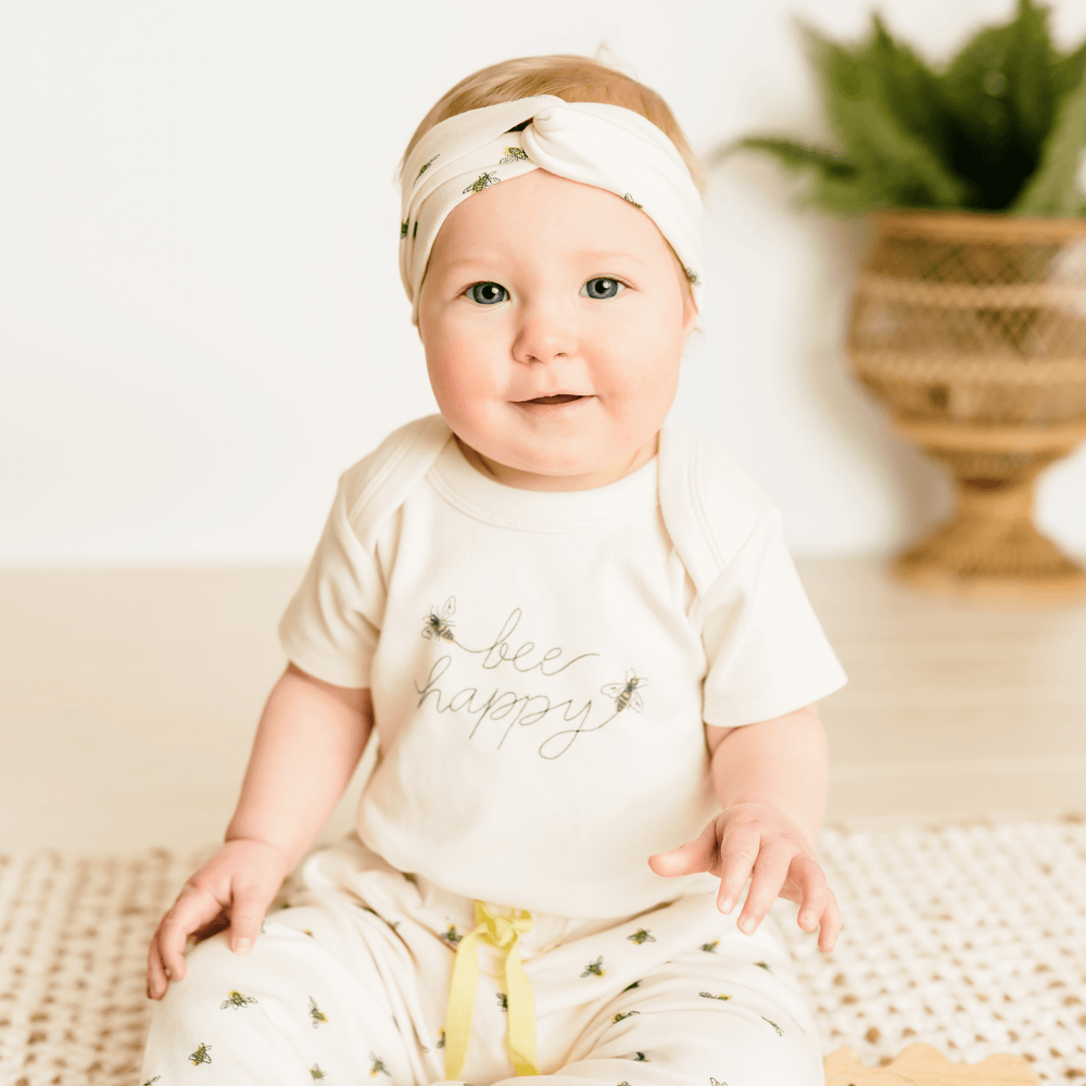 "Bee Happy graphic short sleeve bodysuit for babies, featuring a cheerful design and soft fabric."