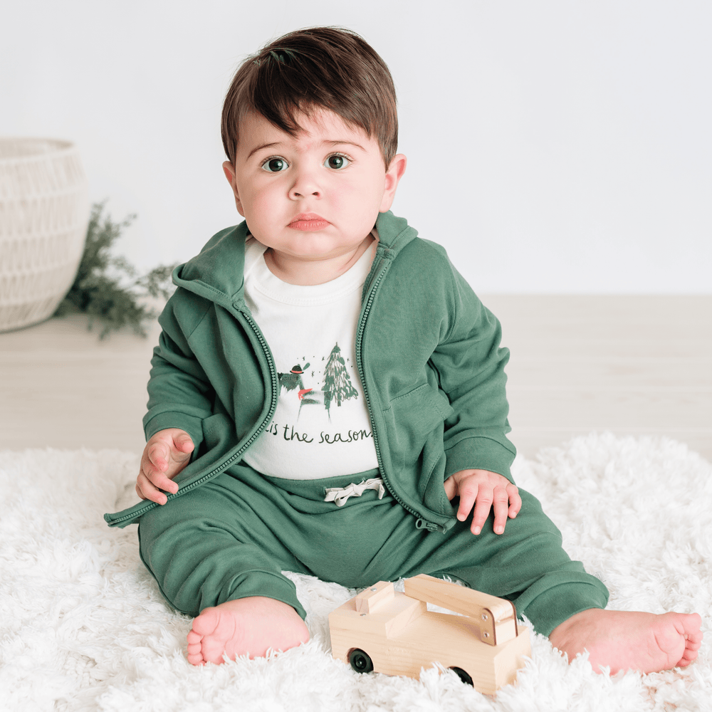"Graphic bodysuit for babies featuring 'Tis the Season' design, perfect for festive occasions."