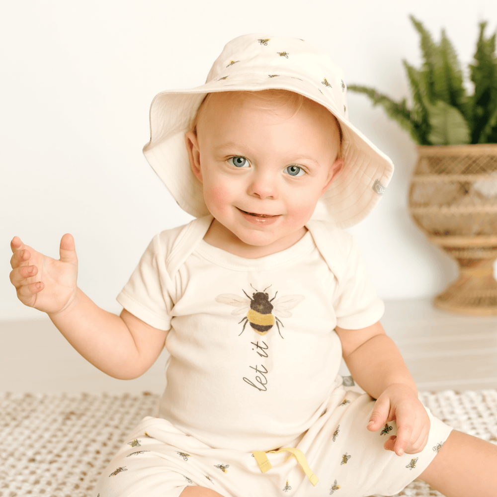 Short sleeve graphic bodysuit for babies featuring "Let It Bee" design. Perfect for stylish and comfy outfits.