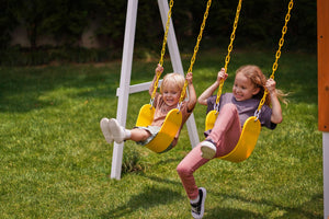 Compact wooden toddler swing set for outdoor play, perfect for babies and kids in a forest setting.