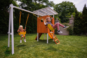 Compact wooden toddler swing set for outdoor play, perfect for babies and kids in a forest setting.
