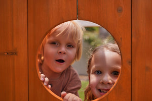 Compact wooden toddler swing set for outdoor play, perfect for babies and kids in a forest setting.