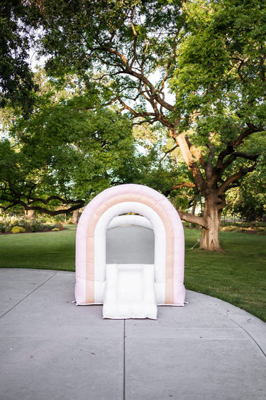 Mini Sherbet Pink Rainbow Bounce House for outdoor playsets, perfect for kids' fun and active playtime.