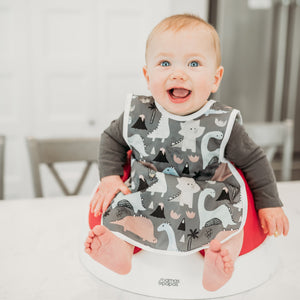 Dinosaur Drawing Bapron for babies, angled view showcasing fun design and practical use for mealtime messes.
