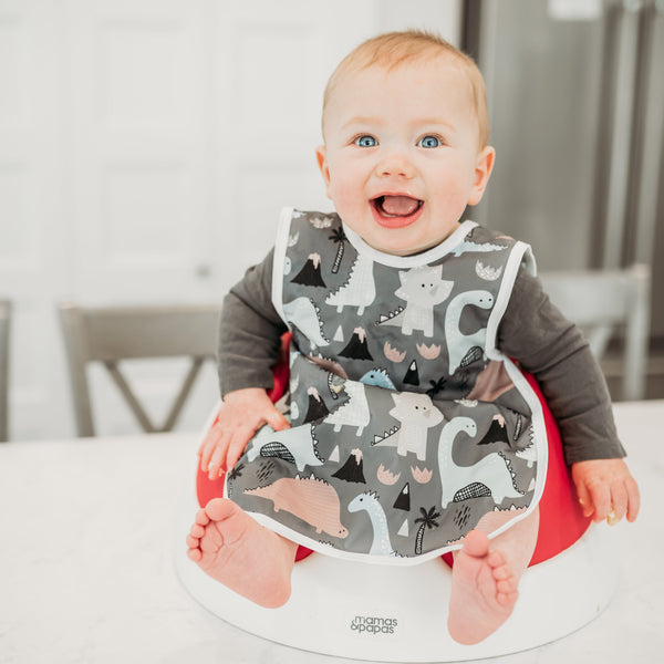 Dinosaur Drawing Bapron for babies, angled view showcasing fun design and practical use for mealtime messes.