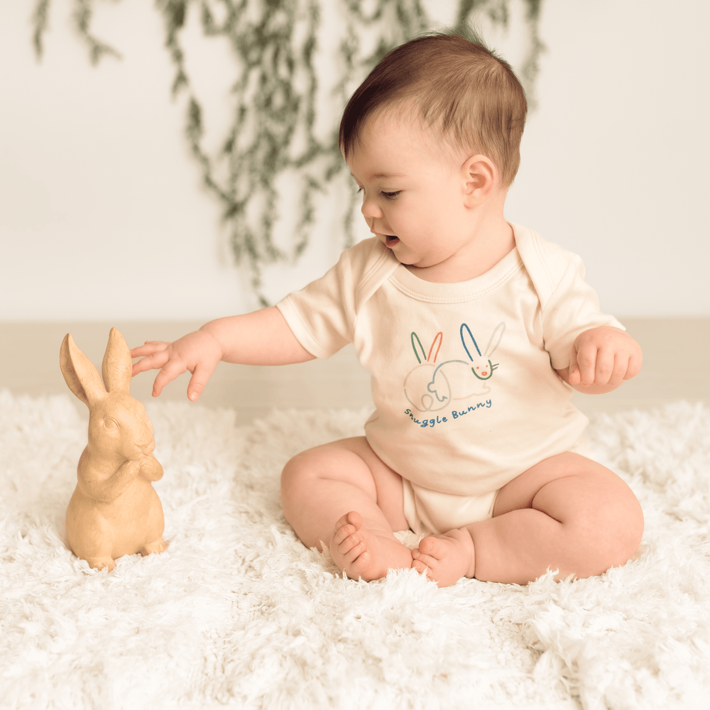 Snuggle Bunny graphic bodysuit for babies, short sleeve design, perfect for comfort and style.