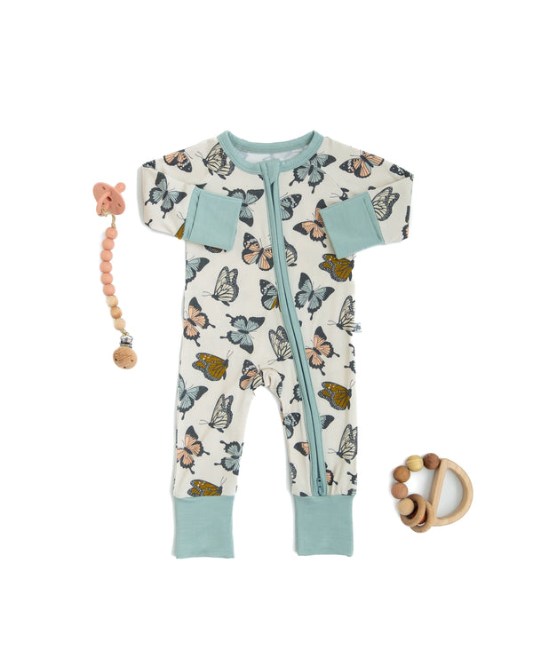 Social Butterfly Zipper Lounger for babies, cozy loungewear in playful design, shown from angle 3.