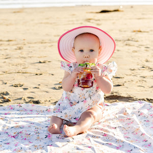 Pastel Floral Flutter Bapron for babies, angled view showcasing vibrant floral design and flutter sleeves.