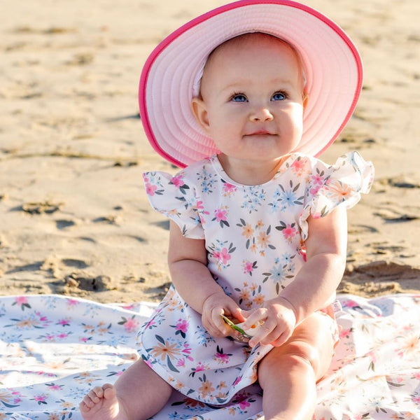 Pastel Floral Flutter Bapron for babies, angled view showcasing vibrant colors and playful design.