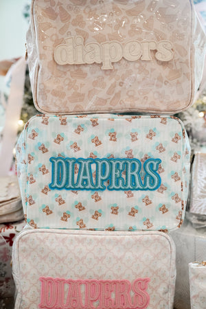 XL Diapers in a clear coat travel bag, angled view showcasing convenience and portability for parents on the go.