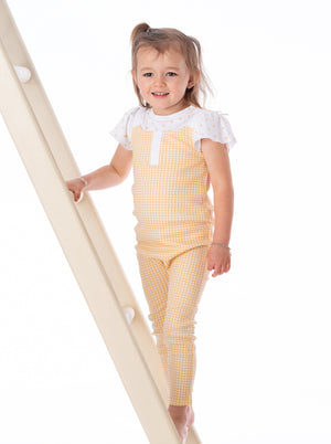 Organic cotton overall in butter gingham pattern, angle view, perfect for babies. Soft, stylish, and eco-friendly.