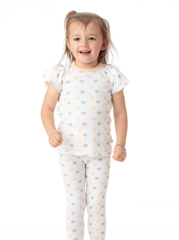 Organic Cotton Ashley Ruffled Tee in Love Lock design, angle view showcasing soft fabric and stylish ruffles for babies.