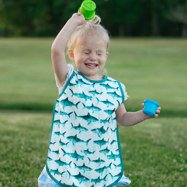 Shark Attack Bapron for babies, angled view showcasing fun design and practical use for mealtime mess protection.