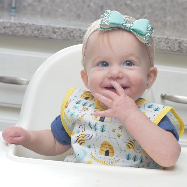 "Busy Bees Bapron for babies, stylish and functional, shown from an angled view."