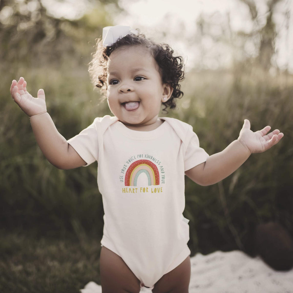 Graphic bodysuit featuring "Kindness" for babies, perfect for short sleeve comfort and style.