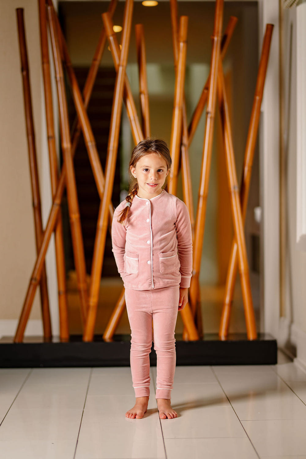Dusty pink velour pajamas for babies, soft and cozy for comfortable play and sleep.