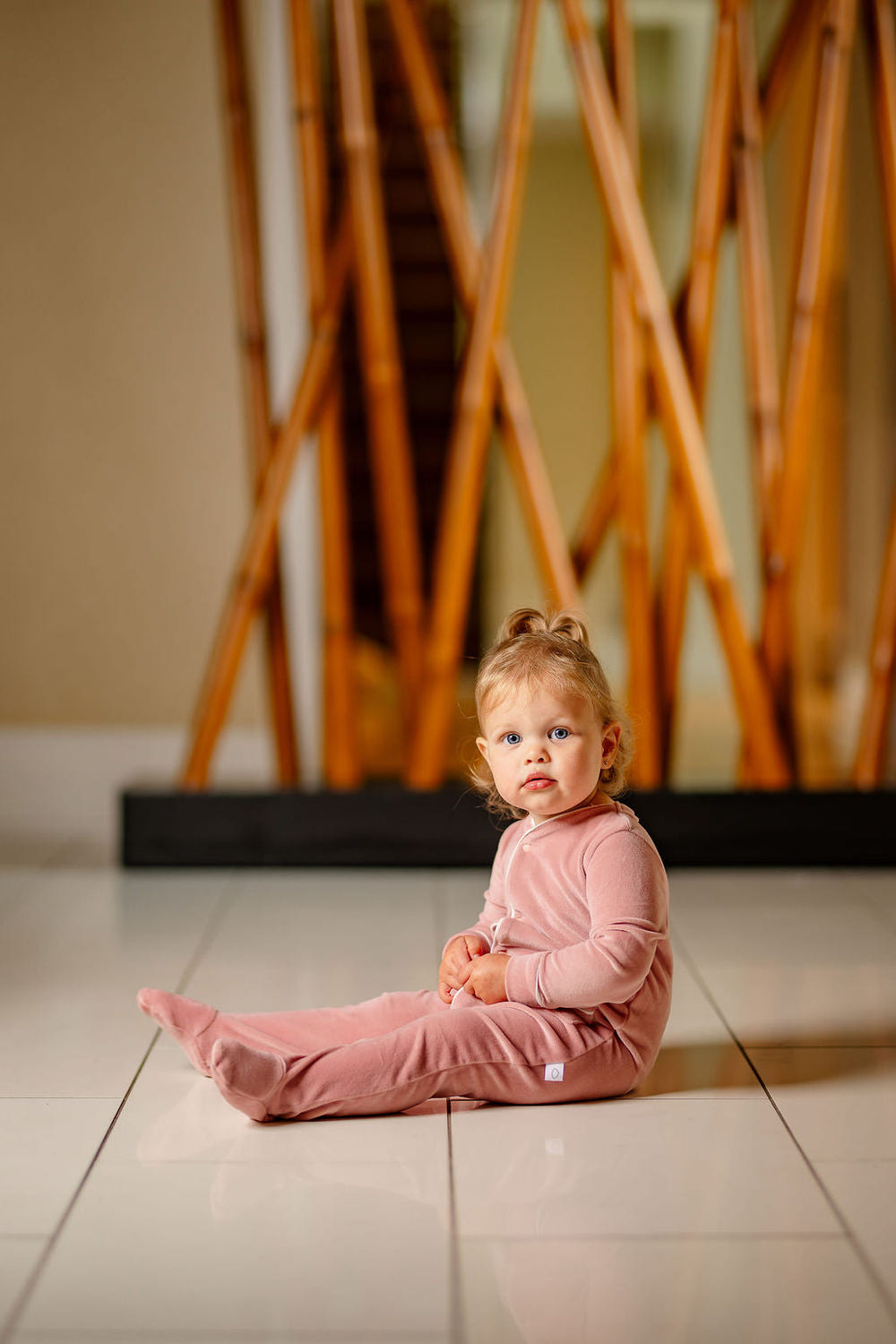 Dusty pink velour footie for babies, soft and cozy, perfect for playtime and comfort.